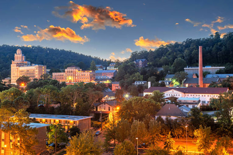 Hot Springs, Arkansas, townscape and mountains at sunset.