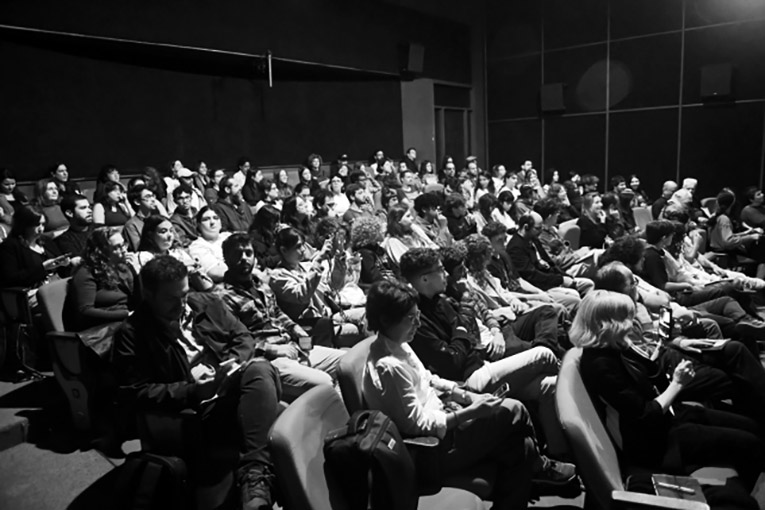A black and white shot of an audience attending a screening.