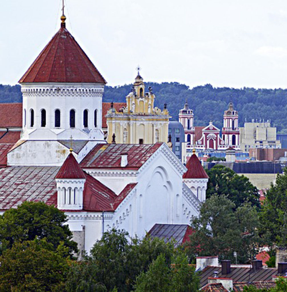 Cityscape of Vilnius with historic buildings foremost in the skyline.